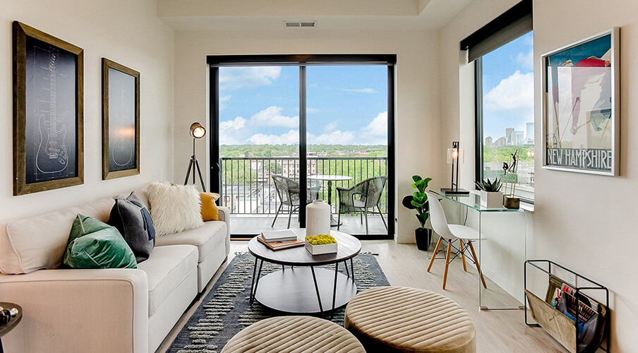 a lumos apartment living room and view of the balcony