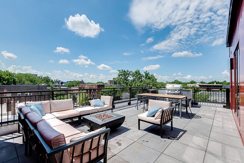 the nox apartment building community balcony with fire pit and seating