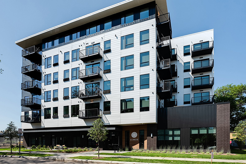 lumos apartments, front of the building on a sunny day.